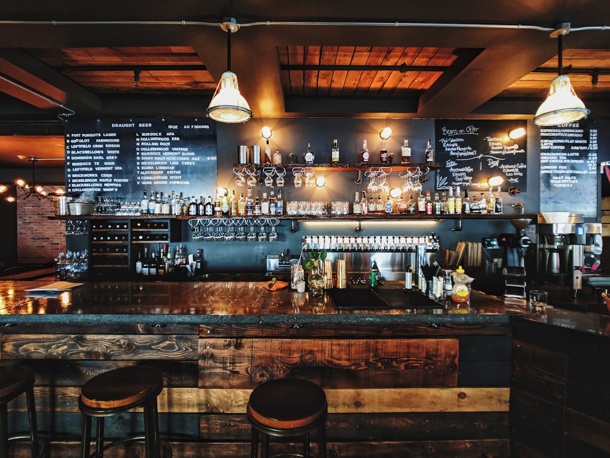 Dark wood bar with lit pendant lights